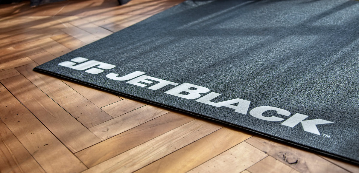 JetBlack_Trainer_Mat_indoor_cycling acessories on wooden floor