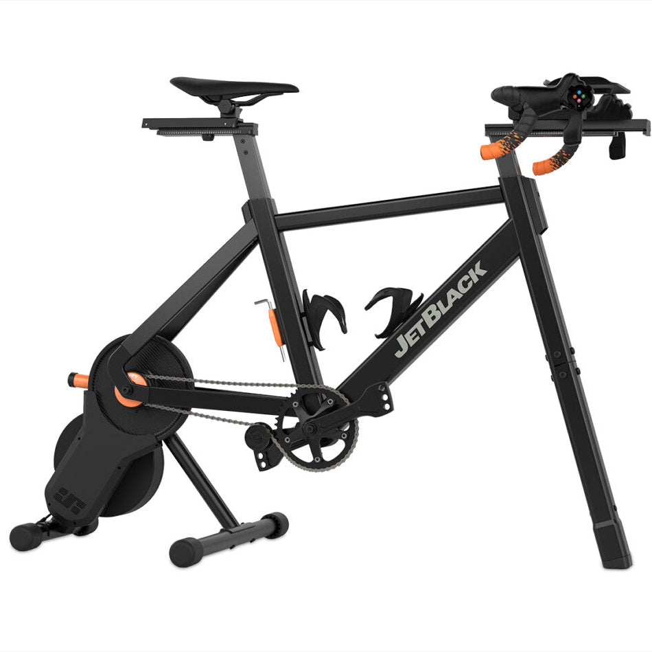 JetBlack indoor cycling trainer on a white background, featuring a black frame with white branding, a black saddle, and orange accent details.